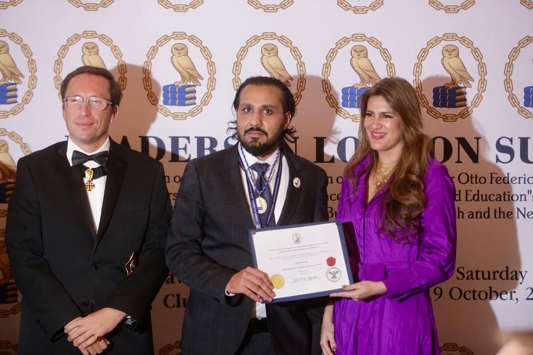 Ahmed Junaid receiving a certificate at a ceremony